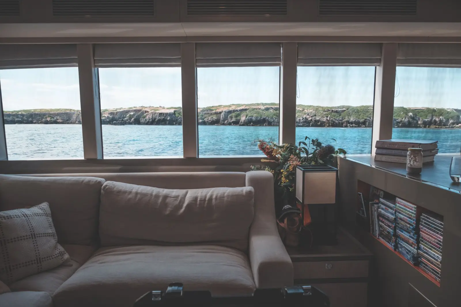 Superyacht salon interior with soft seating and harbour view